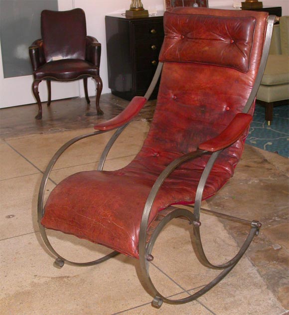 This is an amazing rocking chair from the 19th century.  It has a metal frame and a leather seat and armrests.