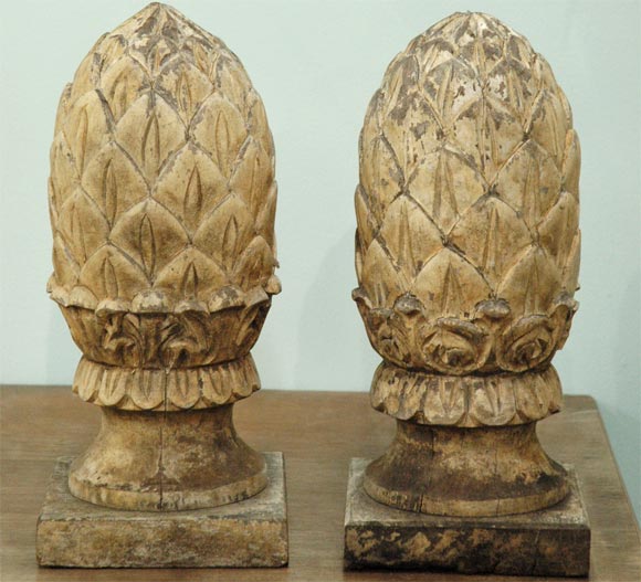 Pair of carved wood pineapple finials or decorative objects. You can see by the pictures that they are not exactly the same, but they look like a pair. They would make great lamps, bookends, or just decorative pieces for in or out.