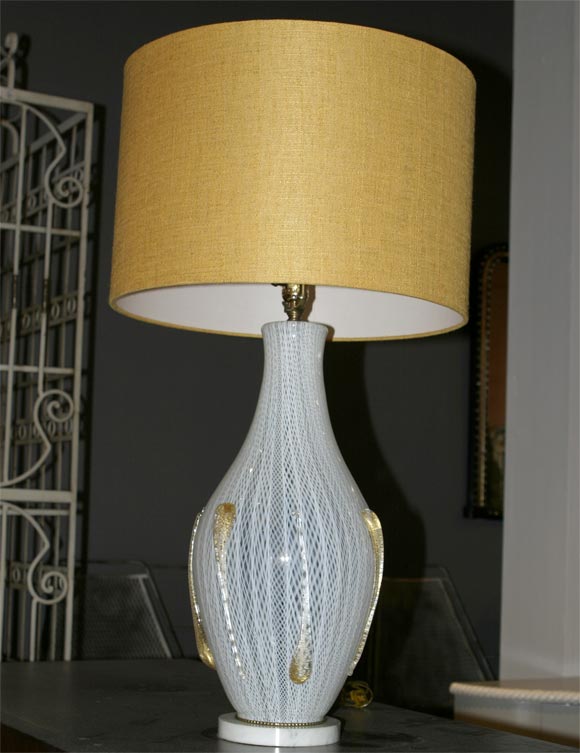 White latticino glass baluster mounted with translucent gold specked teardrops. White marble base. New linen shade. Salviati, ca 1955.