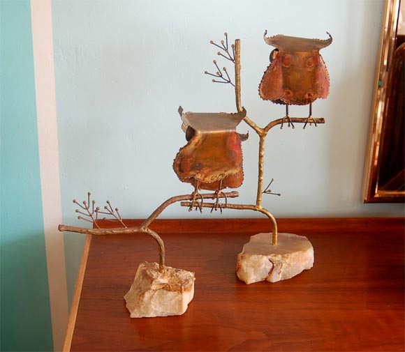 Metal sculptor Curtis Jere fashioned this grouping of three oxidized brass owls with faceted teal blue eyes in 1967. Signed and dated, these little owls - each perched on its own branch - are downright adorable!