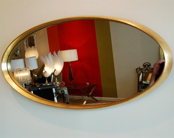 Moderne gilded wood oval mirror. <br />
Original LaBarge sticker on back.