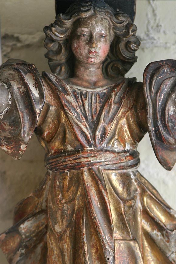 A 17th century carved wood and polychrome angel bracket.