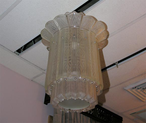 A French Art Deco lantern-type chandelier by Sabino, of multiple molded clear and frosted glass panels, created, circa 1935.