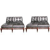 A pair of leather-upholstered and Walnut Settees