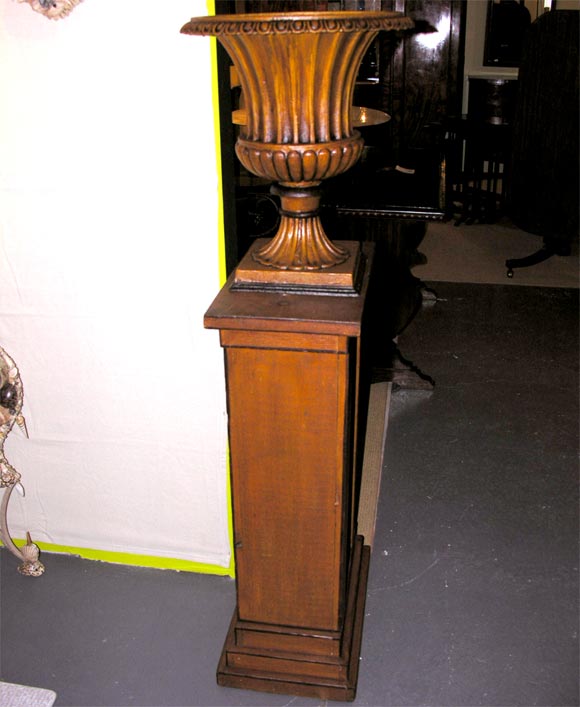A pair of grain painted 19th century wooden pedestals. The pedestals are painted on one side with bows and gathered fruit while on the other side they are plain and can be used on either side depending on the persons tastes. All sides of the