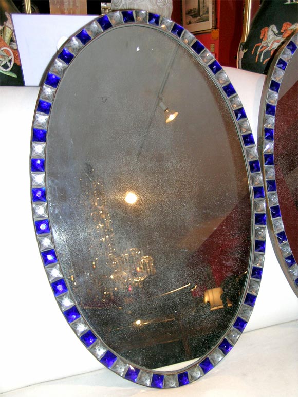 Pair of rish Waterford mirrors with alternate blue and clear glass jewels around oval looking glass.