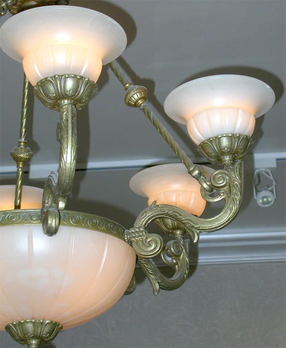 Beautiful 7 light bronze deco chandelier with white alabaster globes. All of the globes are in excellent condition.