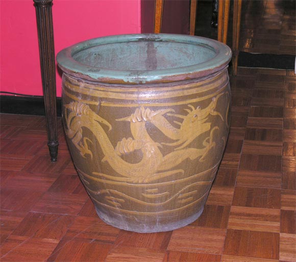 Large chinese earthenware planter with dragon decoration.