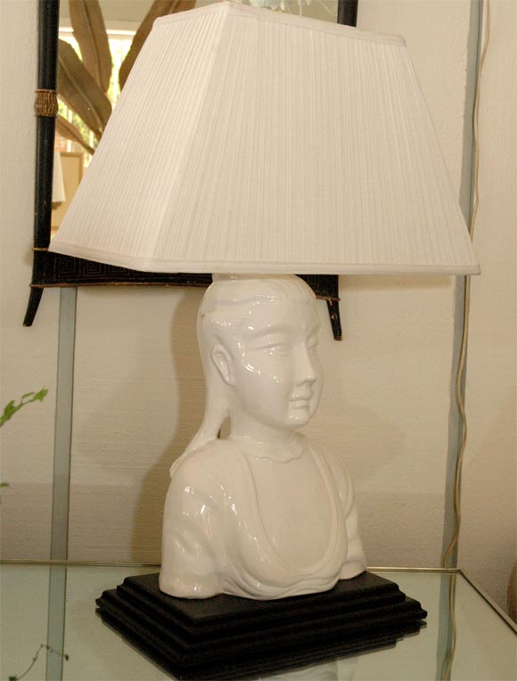 White Asian woman porcelain lamp with black base.