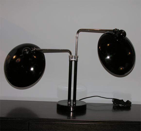 Model #6660 designed by Christian Dell for Kaiser.  2 Adjustable arms in chrome and black painted metal.  Very dramatic large shades that pivot and turn. New silk cord.  Very rare and beautiful lamp.