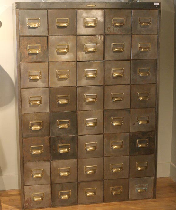 Polished steel filing cabinet from the 1930s with brass handles