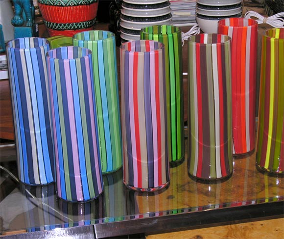 Fantastic, contemporary hand blown striped vases by Anders Rydstedt. A New York artist. Eight different color ways. Signed. We have two vases in stock. One is lots of red with a cream stripe. The other vase is red, lime and yellow. They are both on
