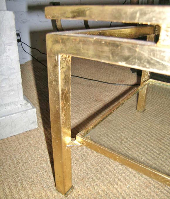 Maison RAMSAY bi-Level cocktail table in gilt metal with elegant details. Table features double levels of glass, with the top level suspended above the frame (see details).