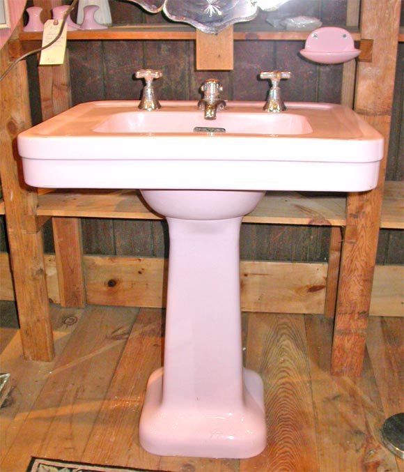 Pink china pedestal sink with original faucet.