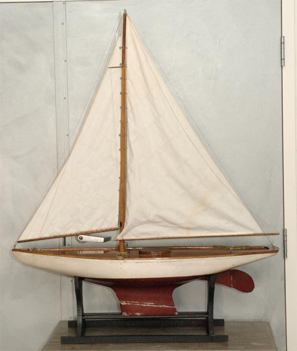 One of the larger ponds boats we have seen. It has two sails and is painted white and red with all the usual fittings. An attractive item to place in that spot to draw the eye. 