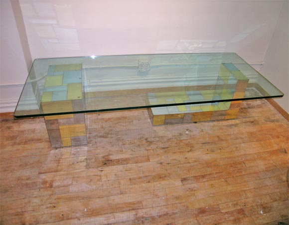 Glass top rest  on two   chrome and brass sculptural forms