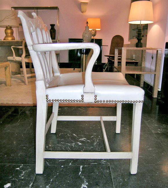 Set of four armchairs in painted wood with leather upholstery and hobnail trim.  From the residence of Lila and DeWitt Wallace in Mt. Kisco, NY.