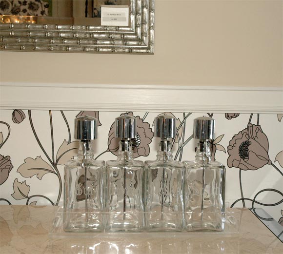 Decanter set of 4 bottles with lucite holder. Vodka, Scotch, Gin, Bourbon with chrome pump heads.