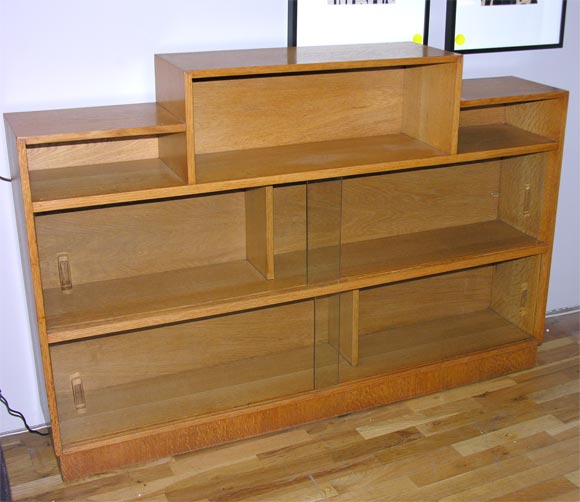 oak bookcase with glass doors attributed to Hugo Gnam