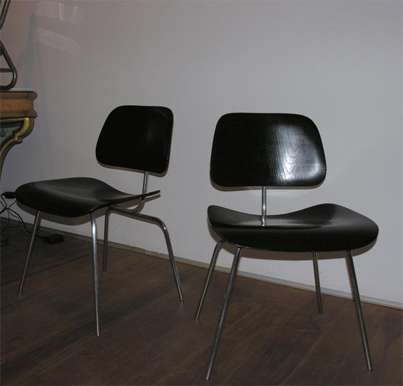Pair of Charles Eames DCM black molded plywood seat and back on chrome frame.Labeled