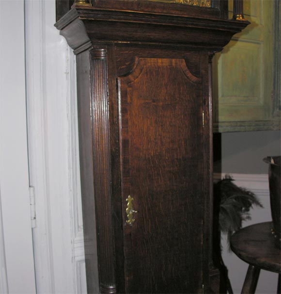 An 18th Century English oak and mahogany eight day tall case clock by William Latham of Macclesfield, the brass dial with much original silvering extant, the hood with free standing fluted columns, the waist having fluded quarter columns, good