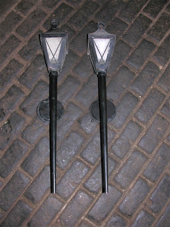 Pair of 1930s French lantern sconces. Whimsical black painted metal sconces.