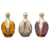 Three Sterling Overlay Colored Decanters