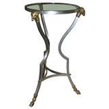 Steel three-legged table with brass ram details