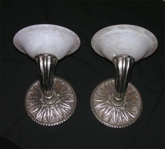 A pair of deco-style wall sconces, single-armed, bronze with alabaster uplight shades.