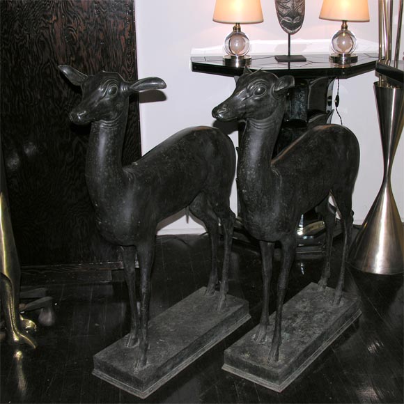 Pair of cast bronze deer, each bearing inset oval plaque, 