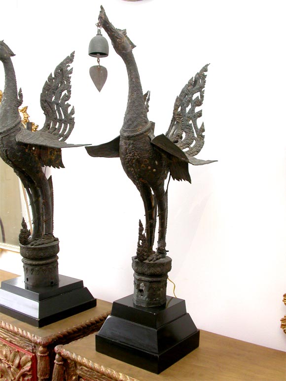 Odd Pair of Bronze Swans originally gilt and mirrored. Used as decoration on a Temple.  Mounted as Sconces with light in the Tails.  Gift of Tony Duquette to Previous Owner.