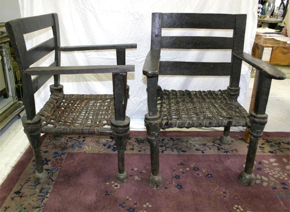 A Pair of West African Ironwood and Leather Chairs