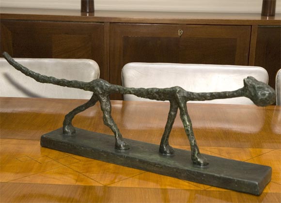 Bronze Giacometti sculpture with green and brown patina titled 