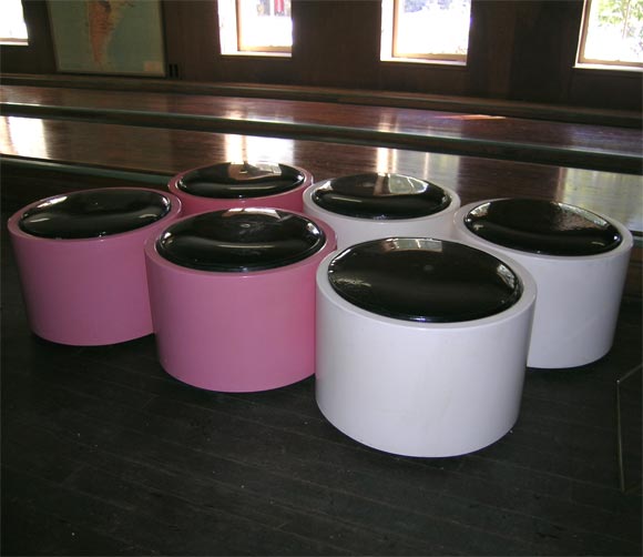 Cylindrical fiberglass poufs with inset round black patented leather cushions. We have three pink ones. Priced individually.  We will repaint these for you, if you prefer.
