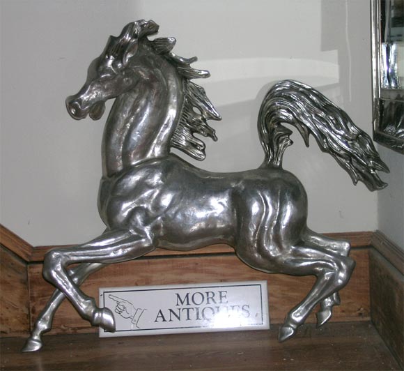 Frisky, prancing horse wall sculpture executed in aluminium.