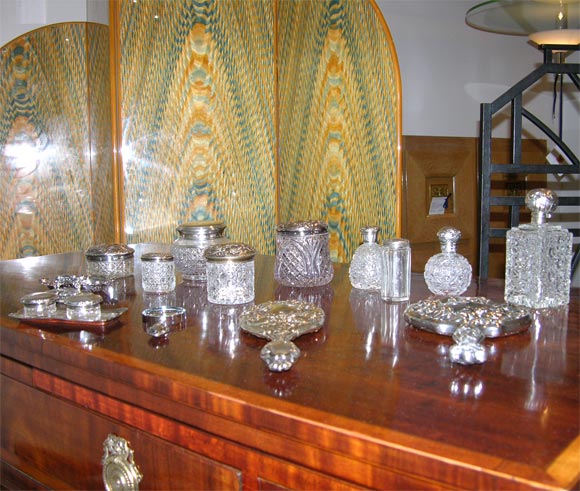 Beautiful Group of assorted Sterling Silver and cut Crystal Vanity top accessories such as perfume bottles, hand mirrors with beveled glass, Trays and small jars. Lovely Filigree and Ropousse work. Many with hallmarks. There are more items available