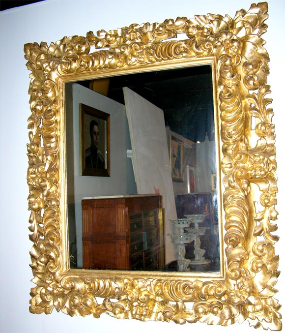 An unusual carved wood and gilted Italian Baroque style mirror with carved 