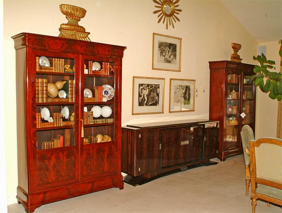 Pair of Louis Phillipe Burl Mahogany Bibliotheques with Fitted Double Doors, each with Highly Figural Burled Lower Panels, raised on Block Feet. <br />
Circa 1830.