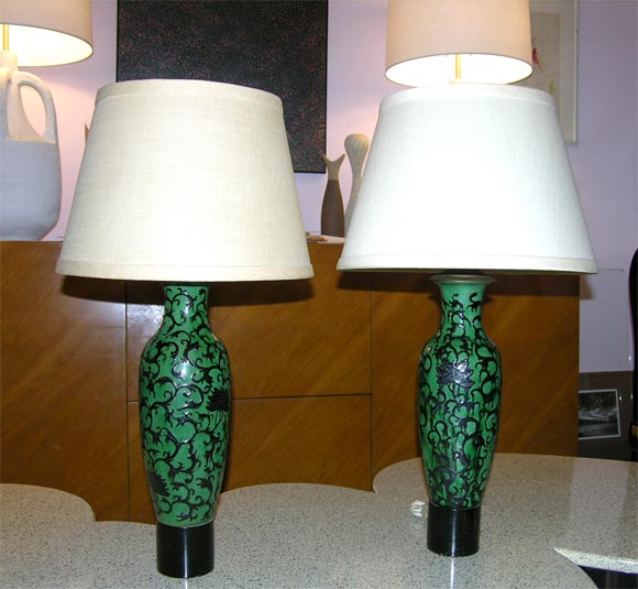 William Haines (1900-1973)
Pair of Chinese ceramic vases mounted as lamps raised on cylindrical wooden bases.
American, circa 1950.