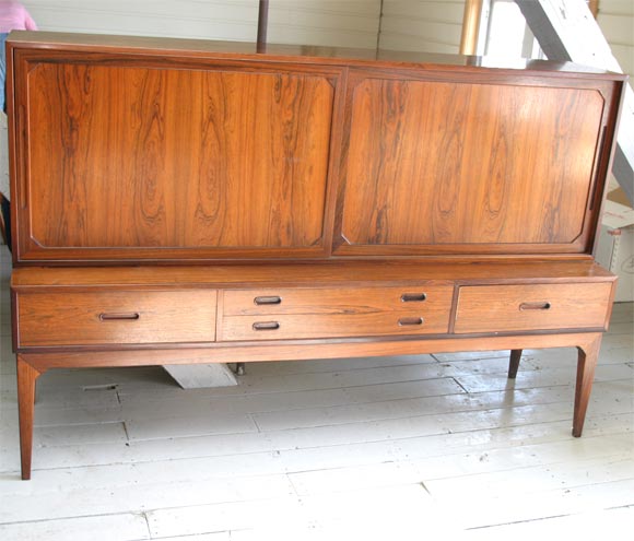 Danish modern step-back sideboard, by Danish modern designer Severin Hansen Jr in finely figured rosewood, with storage cupboards above and four drawers below, mid-20th century modern.
Great storage for cutlery, plates etc.  