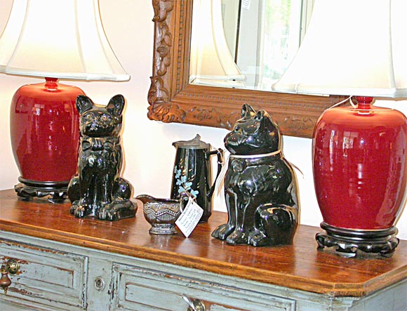 Distinguished Pair of Large High-Gloss Black Glazed Cats.Beautiful glass eyes with a hint of gold wash left around their collars. Please note that they are solid black and not as shown with all the gold/copper effects. That is glare from the camera.