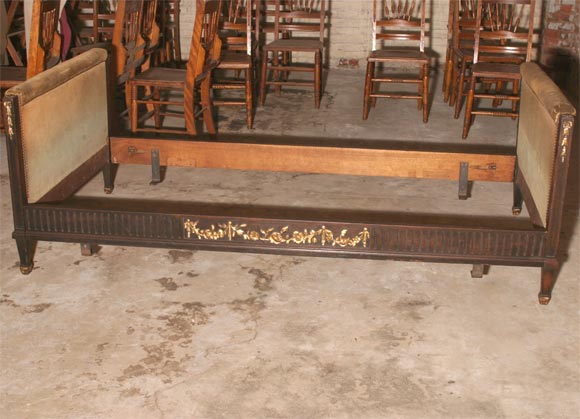 A louis XVI style day bed with green velvet upholstered ends and gilt carved decoration