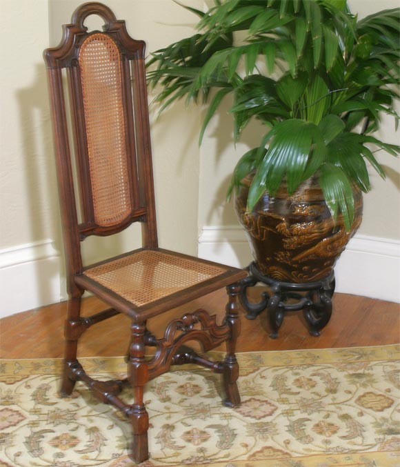 A William and Mary walnut side chair with pierced arched top and caned back and seat