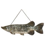 carved wood fish sign