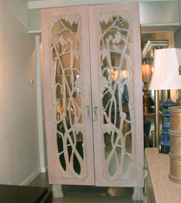 PAIR OF MONUMENTAL ARMOIRES WITH HAND CARVED MIRRORED DOORS