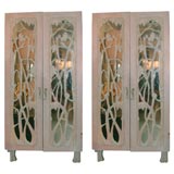 PAIR OF MONUMENTAL ARMOIRES WITH HAND CARVED MIRRORED DOORS