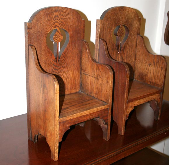 Pair of miniature chair forms; used for display; pierced form with shaped aprons