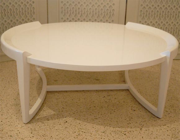 Superbly built, elegant design from this Paul Laszlo coffee/cocktail table, dating to the 1950's.  Curved and connected stretchers support a recessed circular top resting in raised flanges.  Heavy and well made. 24 HOUR HOLD ONLY.