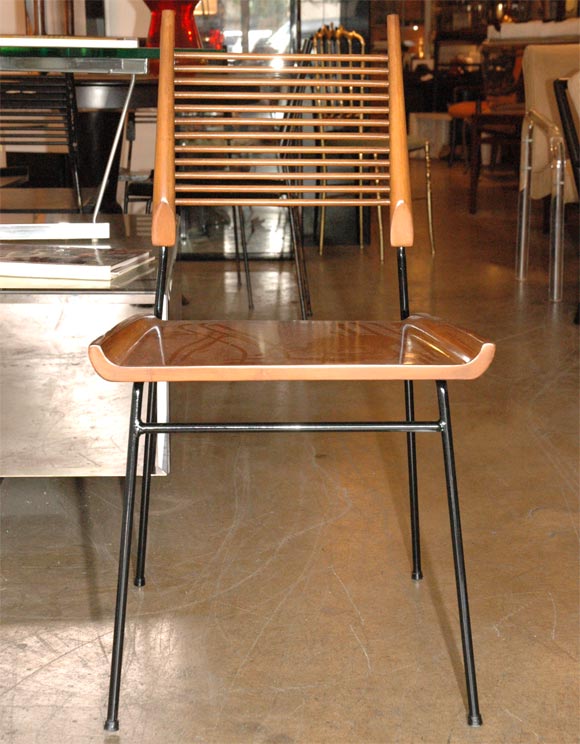 Nice black painted iron and blonde wood dining chairs designed by Paul McCobb.We have 8 chairs that we can split in two sets of 4, please contact dealer for details.