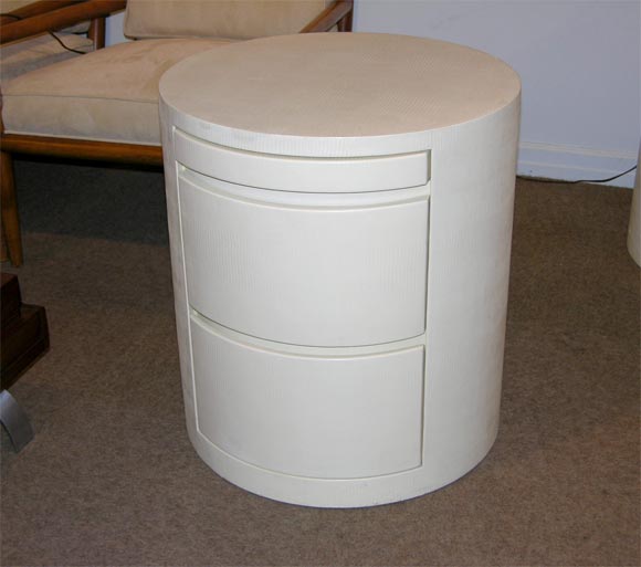 Pair of round bedside tables with 2 drawers and pull out shelf covered in ivory lizard embossed leather designed by Karl Springer, American 1980's